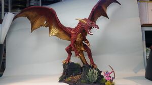 Adult red and gold dragon with tresure hoard