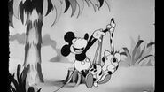 Mickey playing with an animal in the 1929 cartoon