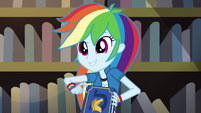 Rainbow Dash holding a yearbook EG3