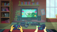 Fluttershy is holding her controller upside down. Is that a Sega Genesis, or a PlayStation 5?