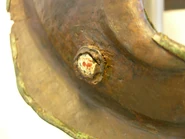 An enamel decorative stud on the cheek guard