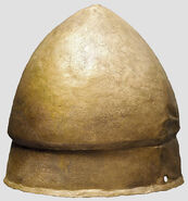 Another view of the helmet, made of bronze with height of 20 cm and weight of 893 g. and having holes on each side for attaching a chinstrap