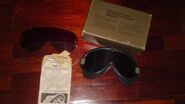 The goggles next to spare lenses, manual and box