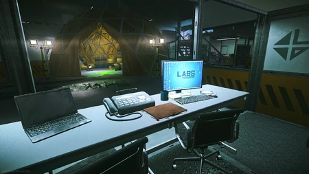 On the white desk right in front of the orange dome