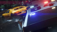 Imagen de pre-lanzamiento de Grand Theft Auto V con un Stanier policial persiguiendo a un Adder.