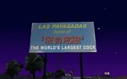 Cartel a la entrada del pueblo donde se informa de la atracción del World's Largest Cock.