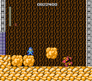 Guts Man usando el Super Arm en "Mega Man", NES.