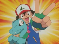 Ash festejando la obtención de Totodile.