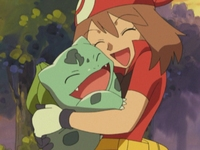 May/Aura abrazando a Bulbasaur.