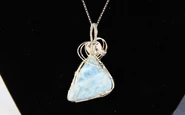 An example of Bennett's work, polished and wire wrapped larimar