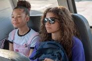 Rue and Gia riding the school bus together.