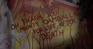 A sort of "praise" written on the wall reads "Oh thank you, mighty Damballa for life after death".