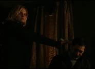 Ivy holding Sean at gunpoint