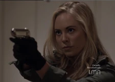 Lucy pointing her pistol at Sean Beauregard