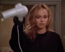Kathryn holding the blow dryer in her murderous act