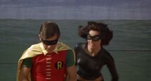 Catwoman sneaks up on an unsuspecting Robin and...