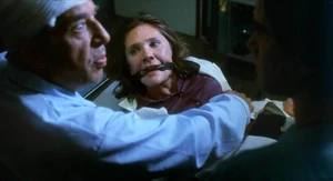 She is protesting and trying to explain, but to no avail