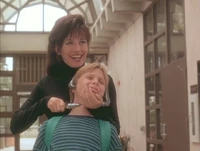 Holding Jeremy hostage in exchange for the weapon...