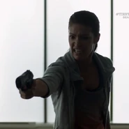 Pam holding Allison McLean at gunpoint