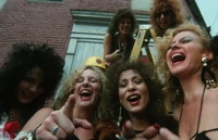 Bad Girls pointing and laughing at the dead man's corpse