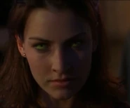 The evil Kelly flashing her green eyes and beginning her transformation