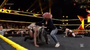 Asuka later tossing Ember Moon out of the ring