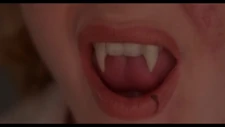 A close-up of Catherine's newly grown vampire fangs
