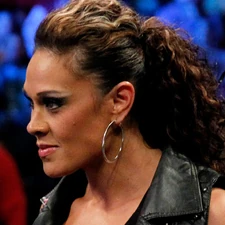 Tamina smirking evilly at ringside