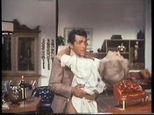 Tina's bullets finish the villainess (Nancy Kovack with Dean Martin)