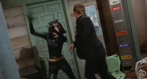 Catwoman avoids Bruce Wayne during the battle!