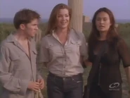 Smiling to see that her armed henchmen are about to release her and to capture Sydney and Nigel again