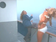 Henchwoman Caroline Field (Dorrie Thomson) gets a kick from Lacy Bond (Sondra Currie) aboard the boat