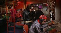 Catwoman closely monitors the screen as Penguin orders missiles to be launched at Batman's boat!