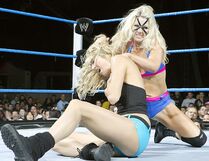 Jillian donning a mask while competing against Stacy Keibler