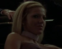 A blonde client watches the sadistic show