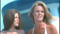 Henchwomen Laura (Susan Mc Iver) and Caroline Field (Dorrie Thomson) aboard their boat