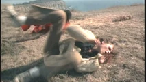 Henchwoman Janette (Laurie Rose) rolling in a cliffside fight