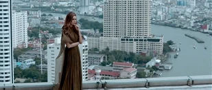 Awaiting her suitcase. She dispatched men wearing identical suits and carrying identical briefcases like a Bond villain