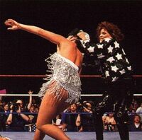 Miss Elizabeth throws Sensational Queen Sherri out of the ring at Wrestlemania 7!