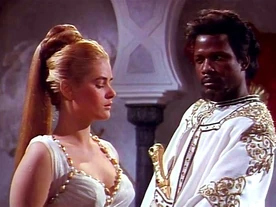King Mansuh inspects Greda, his latest womanly acquisition.