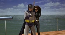 Catwoman pushes Batman off the submarine!