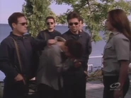 Beating a helpless Nigel after he has been captured by her henchmen