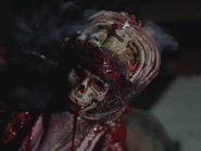 The dagger begins to bleed and smoke as Deadite Shelly screams.