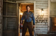Ash Williams stands on the porch of his childhood home.