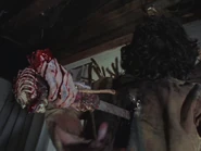 Scotty stabs the Deadite Shelly in the back with the dagger (with her bloody hand still holding the handle).