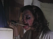 Linda licks the dagger's blade after slicing Ash's arm.