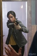 Amanda holding a gun against Ash