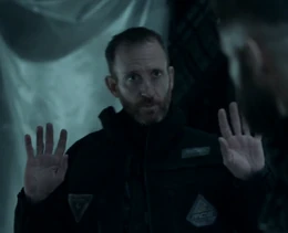 RCE Guard Mason with his arms raised after being disarmed by Amos