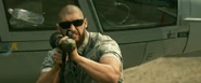 Seen earlier in the film firing an RPG at Barney Ross and Co.