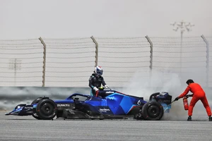 Latifi and track marshal putting out the fire